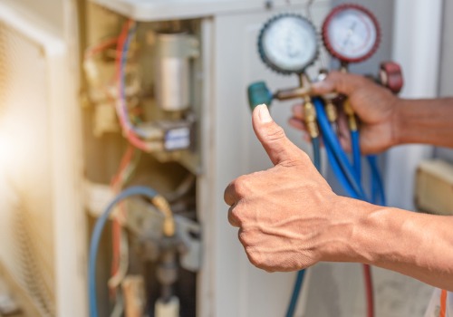 Technician giving a thumbs up after repairing an HVAC system