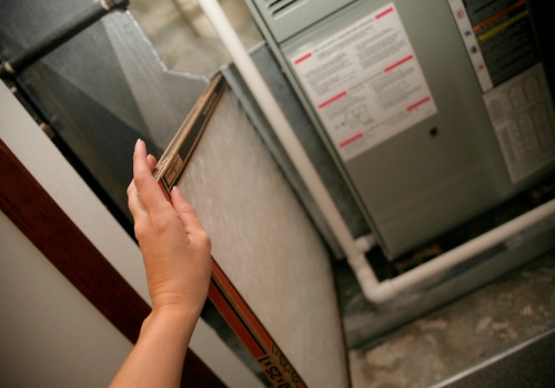 Contractor replacing air filter during Furnace Repair in the St. Louis MO area