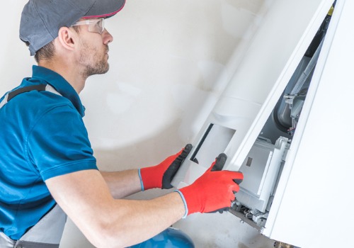 Wide Shot of a Heating Contractor in the St. Louis MO area Working on a Commercial Heating Unit