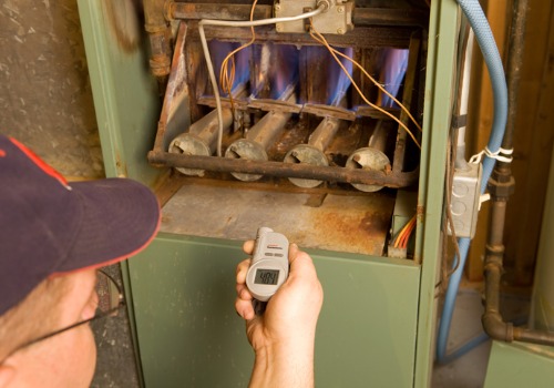 A heating technician inspecting a furnace in the midst of Heating Repair in Florissant MO