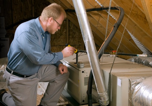 HVAC Contractors in the St. Louis MO area looking at a furnace in the attic