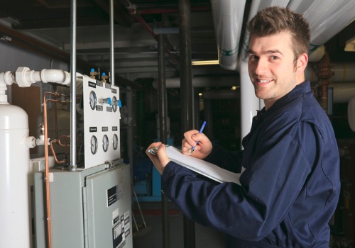 A technician taking notes during Furnace Inspections for Warrenton MO