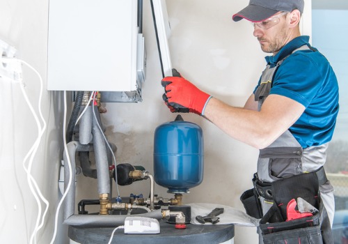 A technician checking the inside of a furnace during Furnace Inspections in Florissant MO