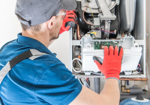 A technician putting a furnace back together during Furnace Inspections for the St. Louis MO area