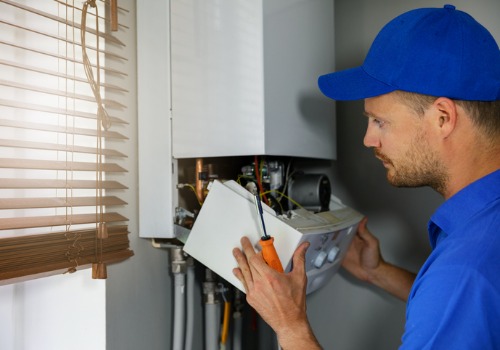 A technician looking at the inside of a furnace during furnace inspections for Kirkwood MO