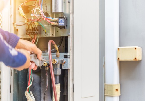 A technician servicing an AC unit, as a part of HVAC Repair in the St. Louis MO area