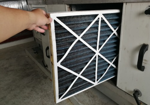 Replacing an air filter during Furnace Inspections in the St. Louis MO area