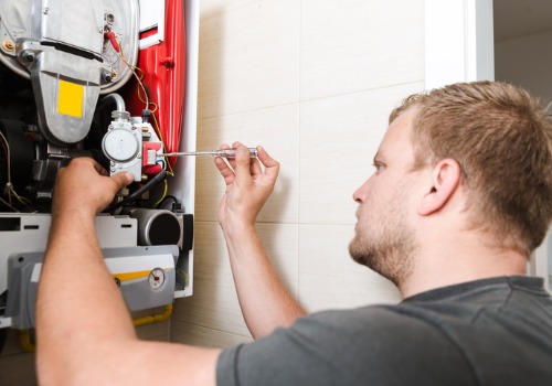 A technician repairing a furnace as a part of Heating Service in the St. Louis MO area