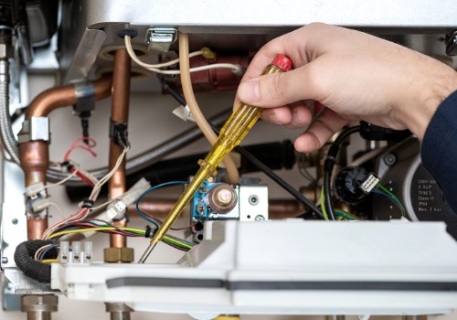 A closeup of someone using a screwdriver to repair a furnace during HVAC Repair in the St. Louis MO area