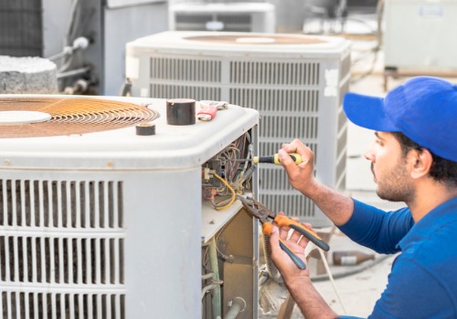 An expert helping repair a rooftop ac unit during service for Heating and Cooling in Florissant MO