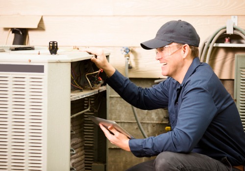 A happy technician performing Air Conditioning Services in Creve Coeur MO