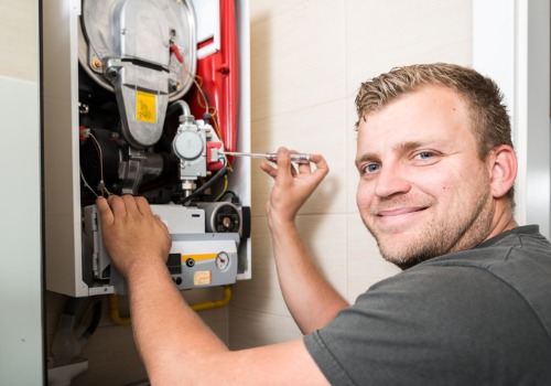 A smiling technician after providing service for heating and cooling in the St. Louis MO area