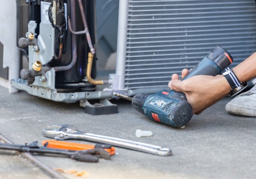 Air conditioning maintenance being done on a residential AC unit