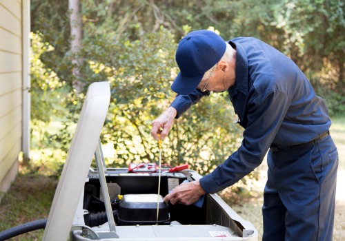 An older technician performing air conditioning maintenance in Florissant MO