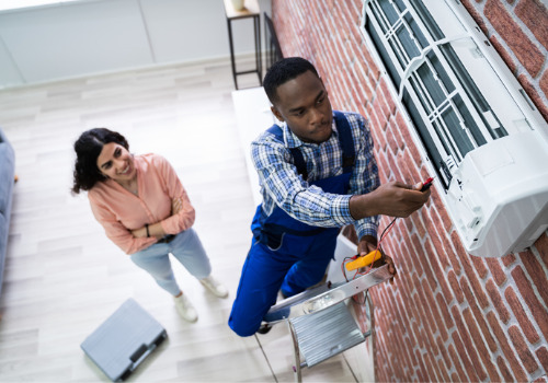 A man assisting a resident with air conditioning repair in the St. Louis MO area