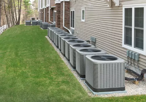 A row of HVAC units is seen. Xcell Williams performs Air Conditioning Maintenance in Wentzville MO.