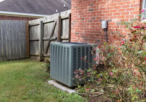 An AC unit is seen outside a house. Xcell Williams does air conditioning repair in Wentzville MO.