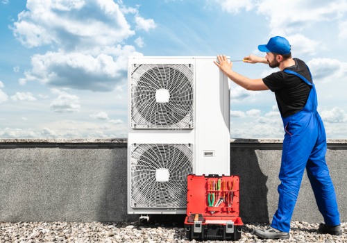 A tech is seen servicing an HVAC unit. Xcell Williams provides HVAC service in Florissant MO.