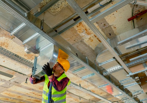 A tech is seen installing HVAC ductwork. Xcell Williams performs heating and cooling in Warrenton MO.