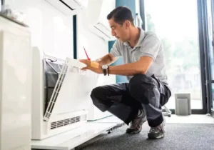 A technician provides air quality services to a homeowner