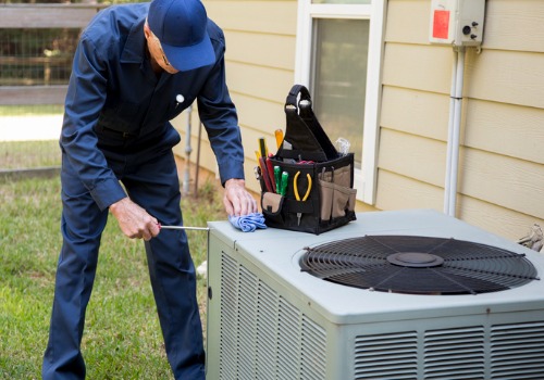 A tech is seen servicing an HVAC unit. Xcell Williams provides HVAC service in Florissant MO.